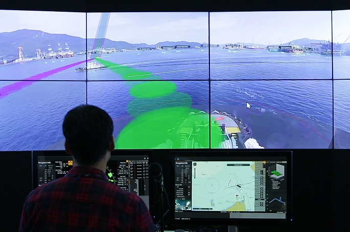 This photo, provided by Samsung Heavy Industries Co. on Oct. 19, 2020, shows a person controlling the company's remote autonomous ship in seas off Geoje Island via a remote control system at a research center in Daejeon, 250 kilometers away from the seas. 