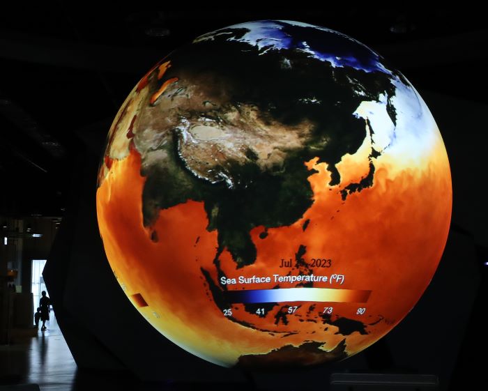 On July 30, amidst a special heat wave declaration in most parts of the country, visitors at the Daegu National Science Museum explore an indoor exhibition featuring the SOS system, representing the El Niño phenomenon during the ongoing climate crisis.