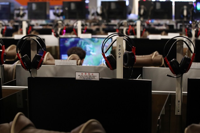This file photo shows a person playing online games at an internet cafe in Seoul. (Yonhap)