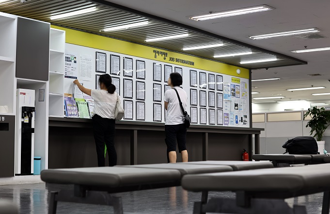 Job seekers look at a job recruitment information board at the Seoul Western Employment Welfare Plus Center in the capital's Mapo district in this file photo taken Aug. 10, 2023. (Yonhap)