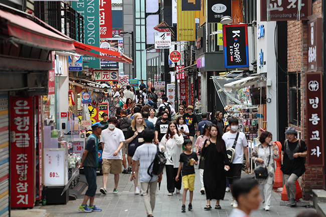 In this Aug. 22, 2023, file photo, people walk the streets of Myeongdong in central Seoul. (Image courtesy of Yonhap)